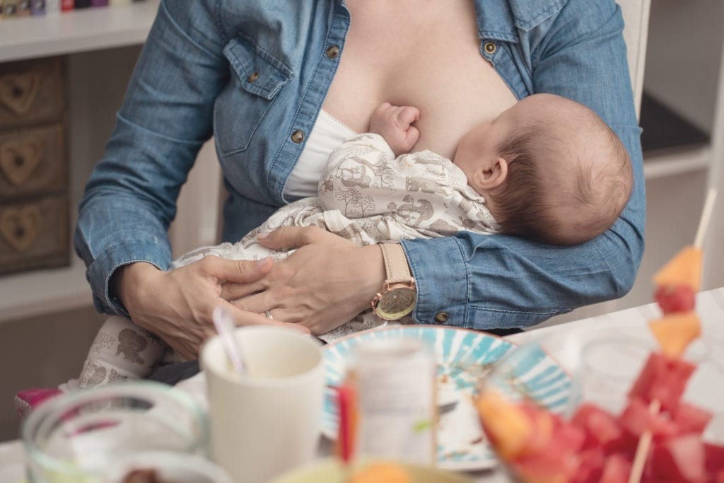 Mother in Jean Jacket Breastfeeding Baby
